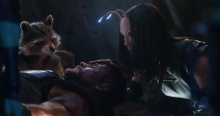HD wallpaper from Avengers: Infinity War featuring Rocket Raccoon, Mantis comforting an injured Thor on a dark background.