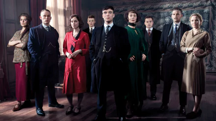 HD desktop wallpaper featuring the main cast of the TV show Peaky Blinders with Cillian Murphy as Thomas Shelby, standing together in period costumes.