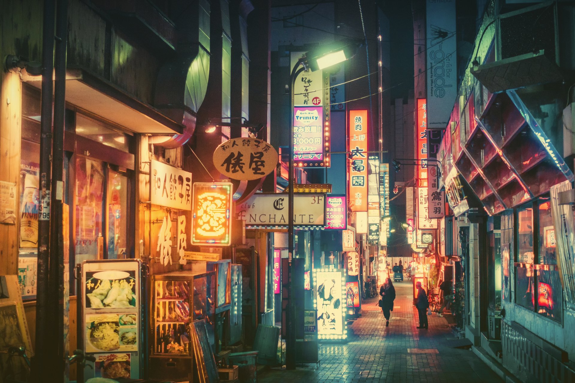 Vibrant neon-lit street scene in Tokyo at night, showcasing Japan's bustling cityscape with colorful signs and illuminated pathways in an HD man-made urban setting.