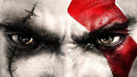 Close-up of Kratos' intense eyes from the God of War video game, featuring his signature red tattoo. This HD desktop wallpaper showcases the detailed artwork and fierce expression of the character.