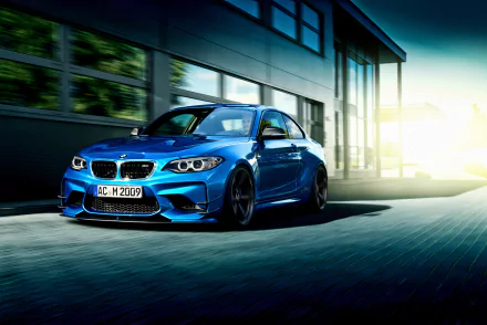 A dynamic 4K Ultra HD desktop wallpaper featuring a blue BMW 2 Series car speeding past modern architecture in bright daylight.