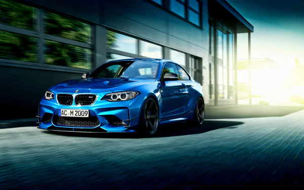 A dynamic 4K Ultra HD desktop wallpaper featuring a blue BMW 2 Series car speeding past modern architecture in bright daylight.