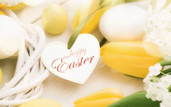 Bright yellow tulips and white eggs with a heart-shaped tag reading Happy Easter create a cheerful 4K Ultra HD desktop wallpaper celebrating the Easter holiday.