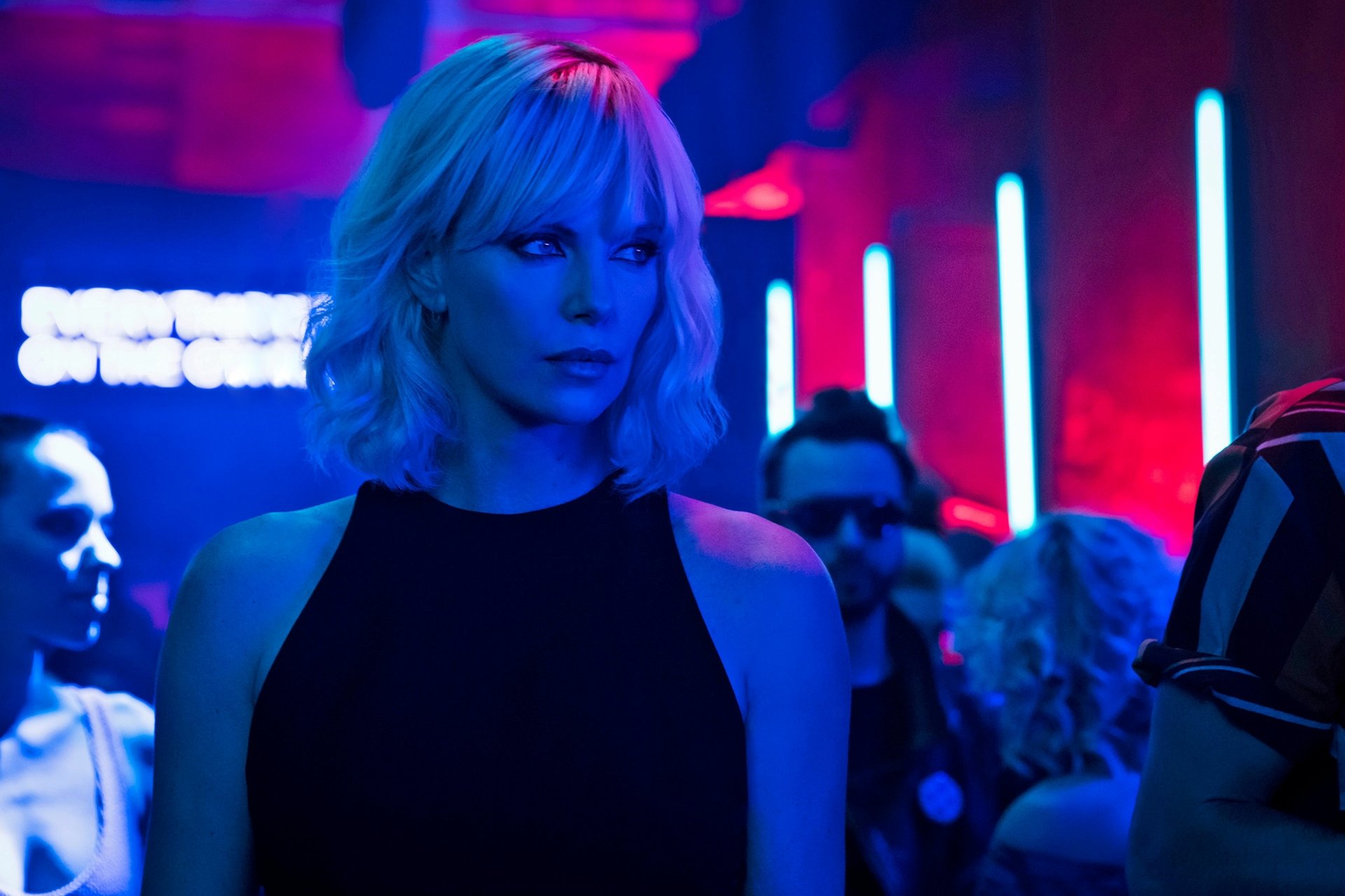 Charlize Theron as Lorraine Broughton in Atomic Blonde, portrayed in a vibrant neon-lit scene, captured in a 4K Ultra HD PC desktop wallpaper.