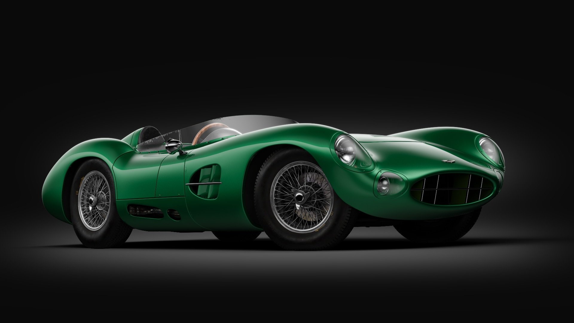 HD desktop wallpaper of a classic green Aston Martin DBR1. The sleek, vintage car stands out against a black background, showcasing its iconic and elegant design.