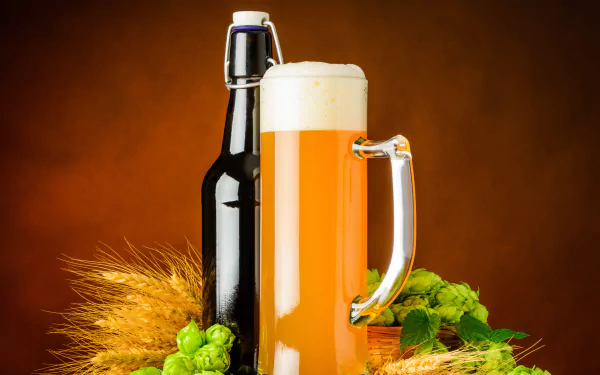 A still life 4K Ultra HD wallpaper featuring a frothy glass of beer, a dark bottle, fresh hops, and barley on a warm brown background.