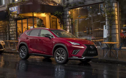 Red Lexus NX SUV parked on a wet city street at night outside a café — 2K Quad HD PC desktop wallpaper/background showcasing Lexus car and vehicle.