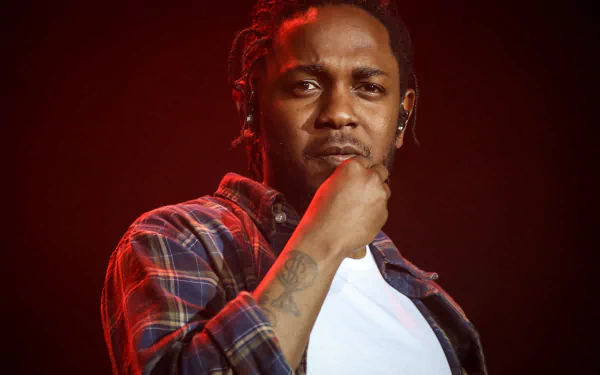 HD wallpaper featuring a contemplative person on stage, providing an artistic background for Kendrick Lamar fans.