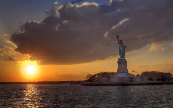 Sunrise over the Statue of Liberty in the USA, captured in stunning 4K Ultra HD with vibrant colors reflecting on the water.