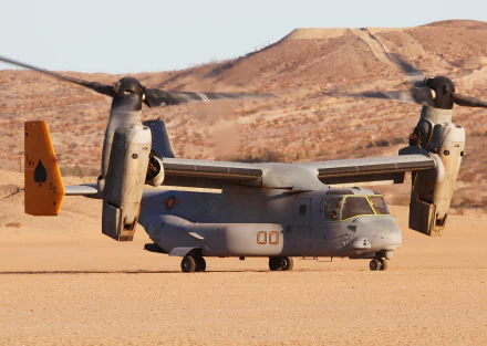 Bell Boeing V-22 Osprey transport aircraft with spinning rotors on a desert runway, featured as an HD PC desktop wallpaper and military aircraft background.