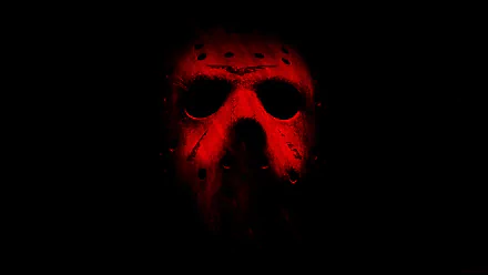 A haunting HD wallpaper featuring Jason Voorhees from the 2009 movie Friday the 13th. The iconic hockey mask is illuminated in eerie red light against a dark background.