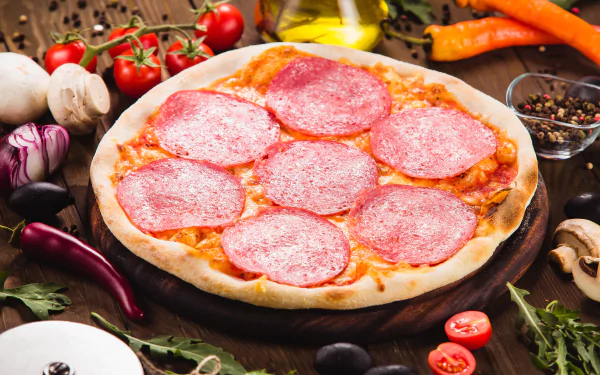 A 4K Ultra HD still life of a salami pizza surrounded by fresh ingredients like tomatoes, mushrooms, and chili peppers on a wooden table background.