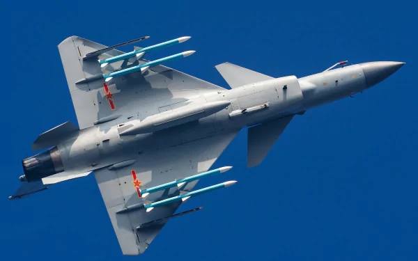 High-definition image of a Chengdu J-10 military jet fighter warplane soaring against a clear blue sky, captured as a desktop wallpaper and background.