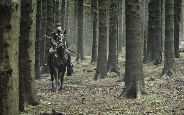 Iwan Rheon as Ramsay Bolton from Game of Thrones rides a black horse through a dense, misty forest in this HD PC desktop wallpaper and background.