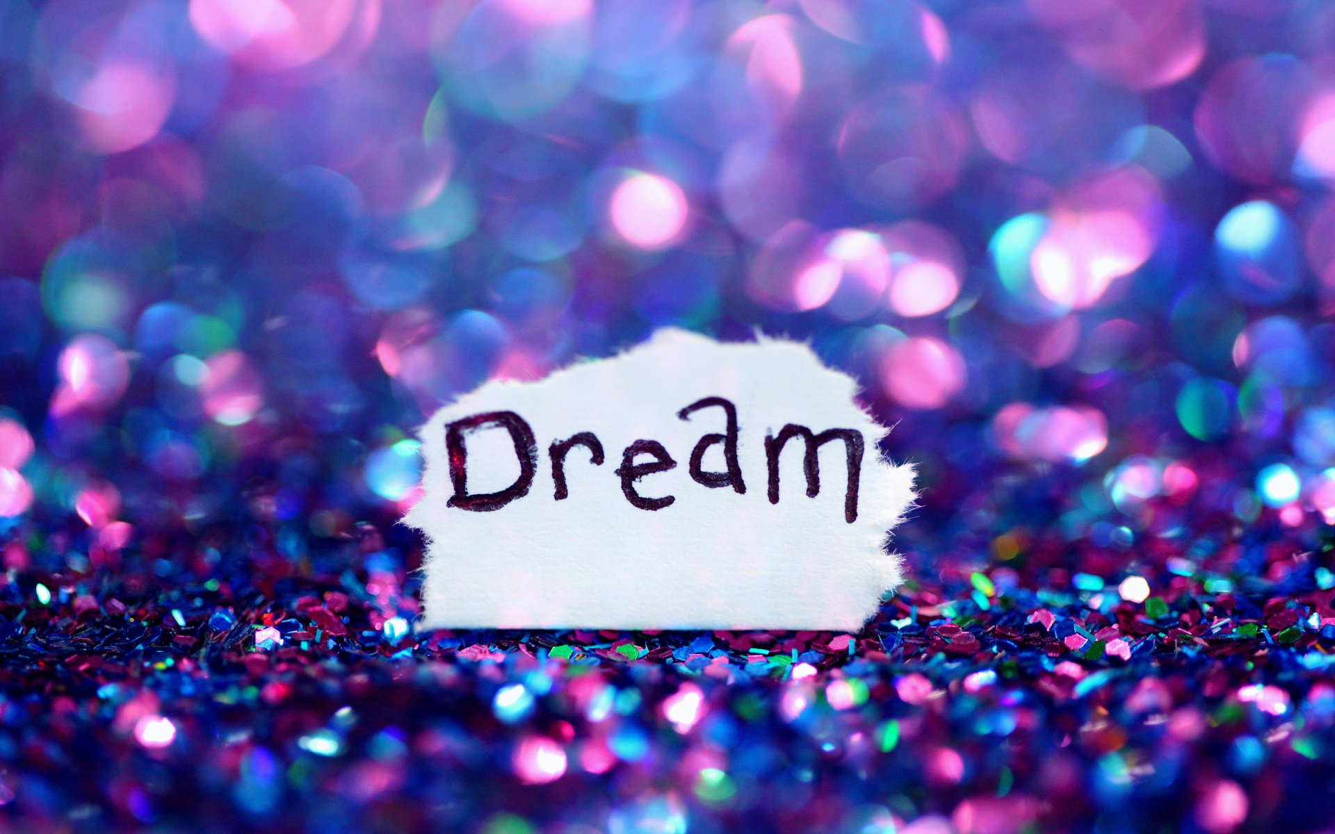 Artistic, dream-themed 4K Ultra HD PC desktop wallpaper/background: torn paper reading Dream set against a shimmering purple-blue glitter bokeh.