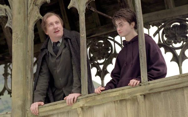 HD desktop wallpaper featuring Remus Lupin and Harry Potter from the movie Harry Potter and the Prisoner of Azkaban, set against a detailed Gothic architectural background.
