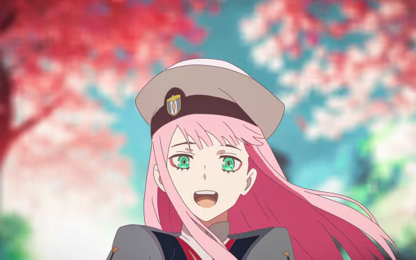 Zero Two from Darling in the FranXX, depicted in an anime style with pink hair and green eyes, smiles joyfully against a vibrant backdrop of pink and blue hues. This HD desktop wallpaper features this popular character.