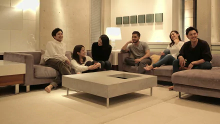 HD desktop wallpaper of people relaxing in a cozy terrace house living room.