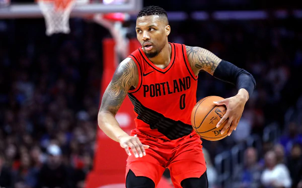 HD desktop wallpaper featuring a focused basketball player dribbling on the court in a Portland jersey.