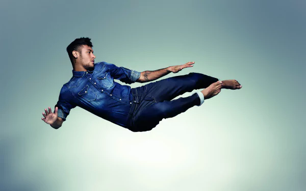 Brazilian soccer star Neymar captured mid-air against a minimalist background, featured in a 4K Ultra HD PC desktop wallpaper showcasing his dynamic athleticism.
