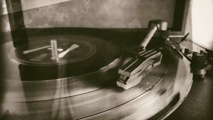 Sepia-toned vintage turntable close-up with a spinning vinyl and gramophone arm, evoking Twenty One Pilots retro music vibes—HD PC desktop wallpaper/background.