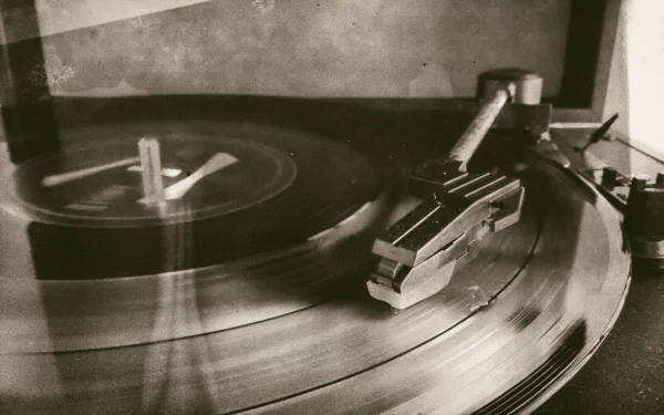 Sepia-toned vintage turntable close-up with a spinning vinyl and gramophone arm, evoking Twenty One Pilots retro music vibes—HD PC desktop wallpaper/background.