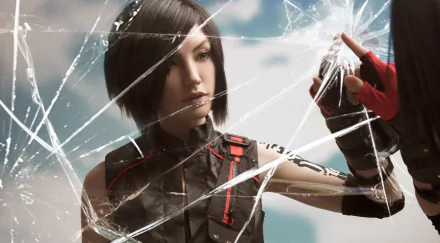 HD wallpaper of a woman cosplaying Faith Connors from Mirror's Edge, with shattered glass effects adding dynamic depth to the PC desktop background.