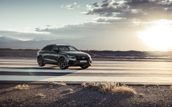 Silver Audi Q8 SUV parked on an open road at sunset, captured in 4K Ultra HD as a striking desktop wallpaper and background.