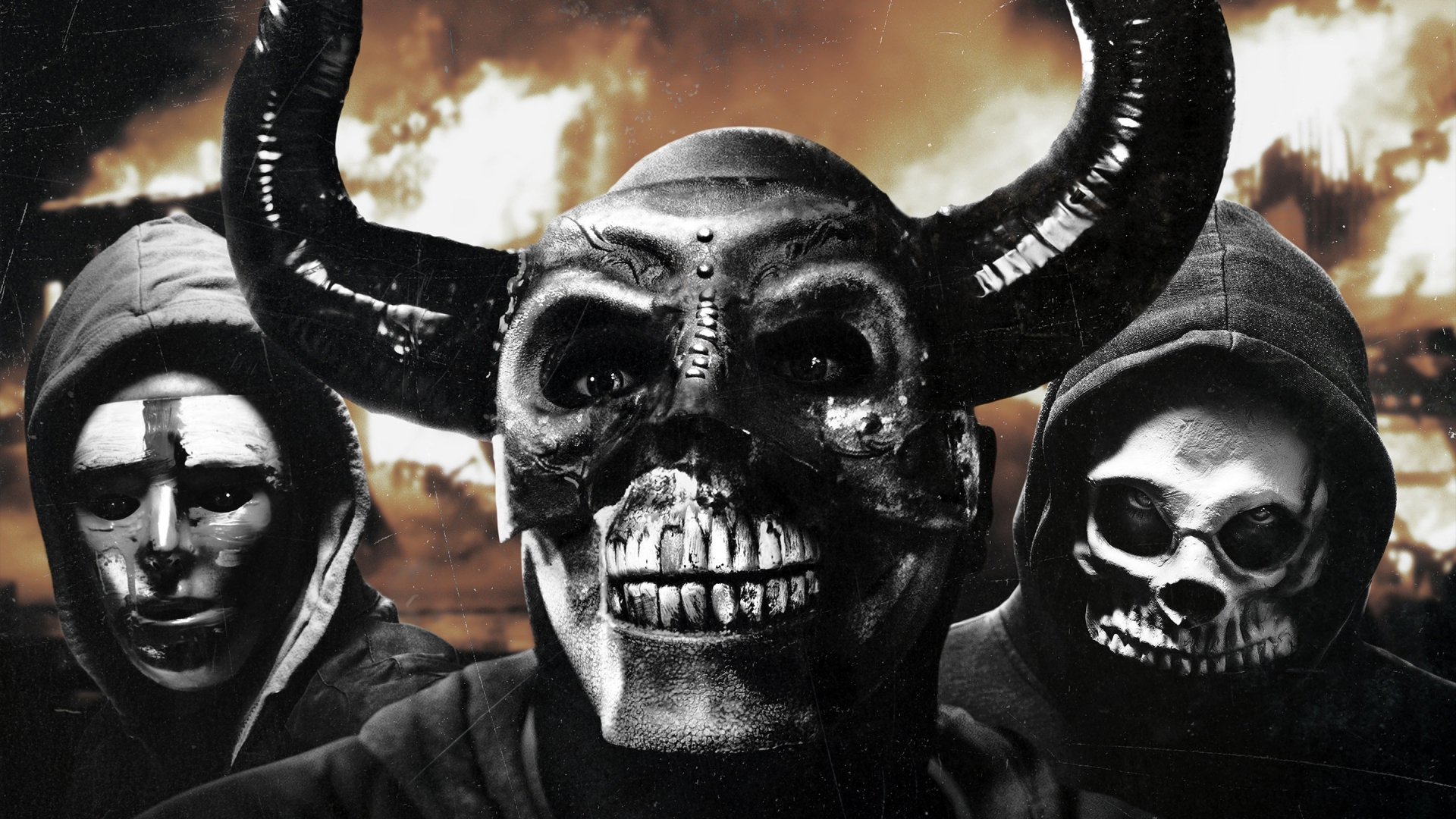 HD PC desktop wallpaper featuring three masked figures from the movie The First Purge, with a dark and ominous sky in the background.