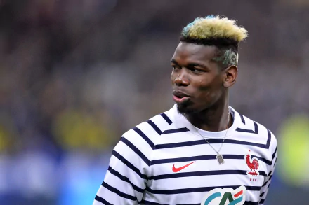 HD desktop wallpaper featuring Paul Pogba in a striped kit with his distinctive blonde-streaked hair.