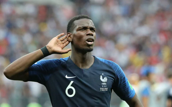 HD desktop wallpaper featuring a focused Paul Pogba in the French national football team jersey, with the number 6, in a stadium setting.