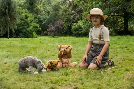 HD wallpaper of a person posing as Christopher Robin with plush toys in a grassy field.