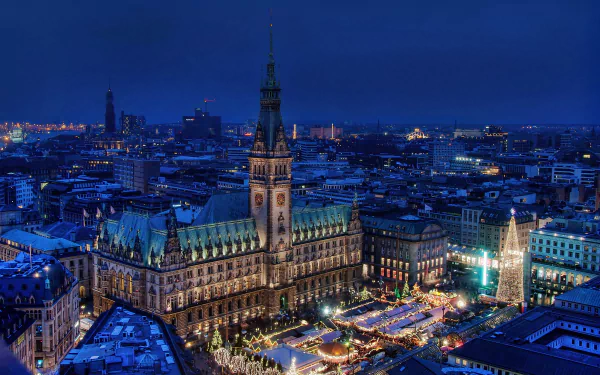 2K Quad HD PC desktop wallpaper and background — Hamburg, Germany city at night: illuminated Rathaus and man-made Christmas market lights across the skyline.