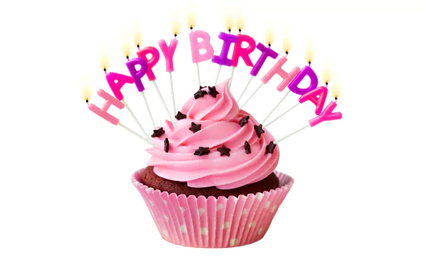 A pink-frosted cupcake with black sprinkles, lit birthday candle sticks spelling HAPPY BIRTHDAY, set against a white background in 4K Ultra HD resolution.