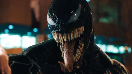 HD desktop wallpaper featuring a close-up of Venom from the movie, showing detailed texture and fierce expression in a night setting.