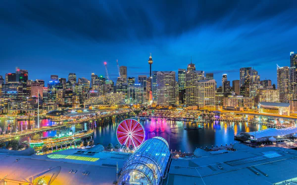 Vibrant night view of Sydney's Darling Harbour with colorful lights illuminating the city skyline, creating a dynamic and lively man-made urban scene in Australia.