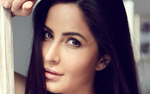 Close-up portrait of an Indian actress with long black hair and brown eyes, celebrity face framed for a 4K Ultra HD PC desktop wallpaper and background.