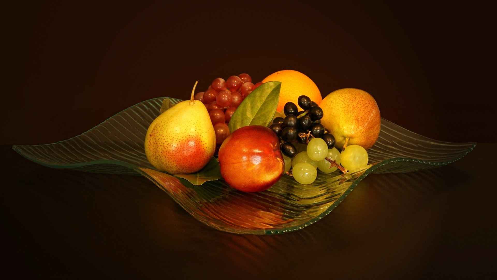 A vibrant still life of pears, grapes, and assorted fruits on a glass dish, captured in stunning 4K Ultra HD as a PC desktop wallpaper and background.
