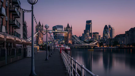 A stunning 4K Ultra HD view of London’s Tower Bridge and London Bridge at dusk, showcasing iconic man-made structures along the River Thames skyline.