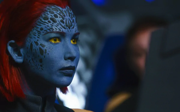 Close-up of Mystique (Marvel Comics) with blue patterned skin and yellow eyes from X-Men: Days of Future Past and X-Men: Dark Phoenix — 5K Ultra HD movie desktop wallpaper.