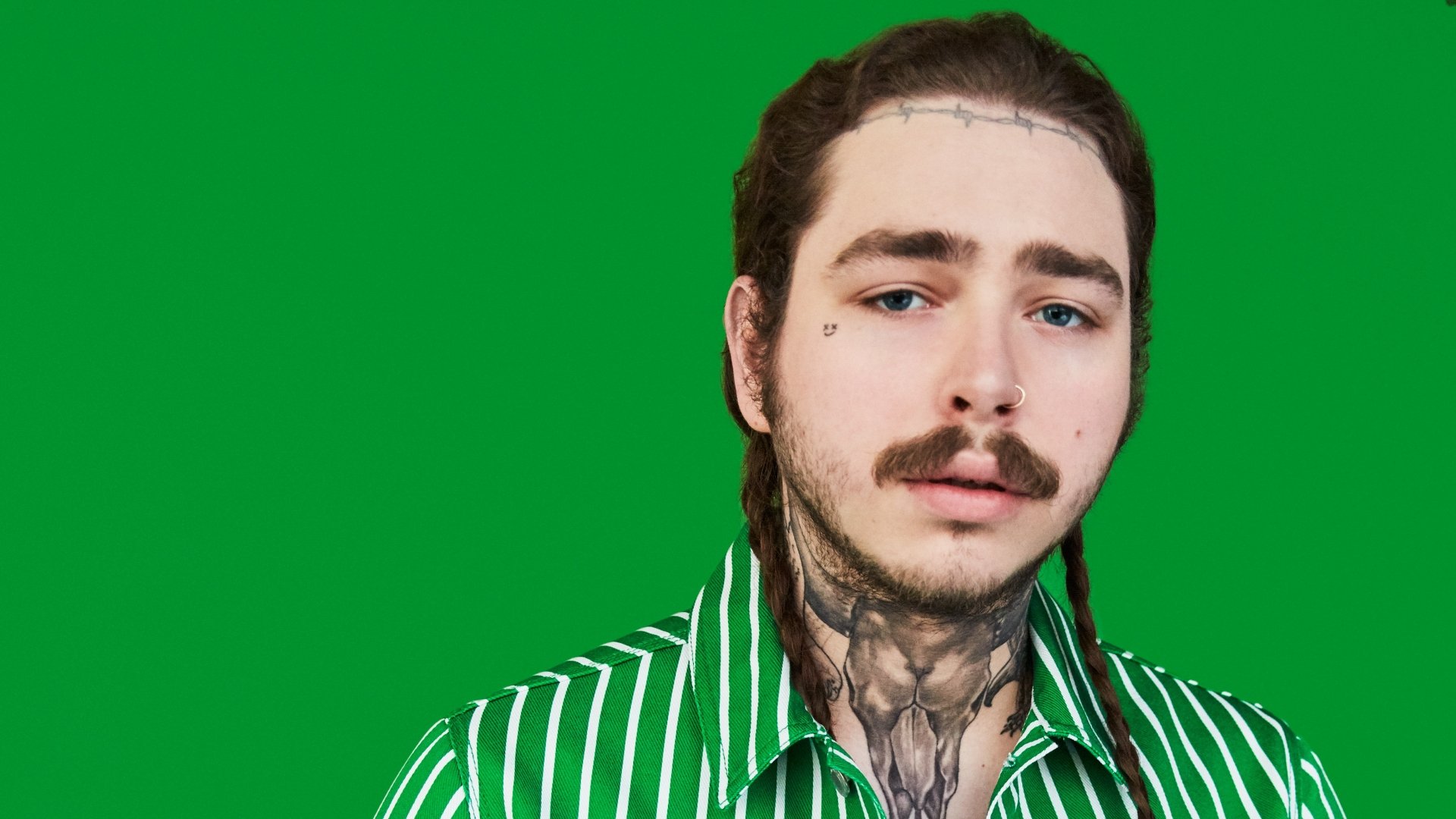 HD wallpaper featuring a man with tattoos and a green-striped shirt against a green background.