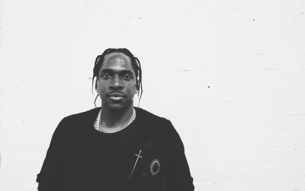HD desktop wallpaper featuring a black and white image of a man standing against a white background, tagged as Pusha T.
