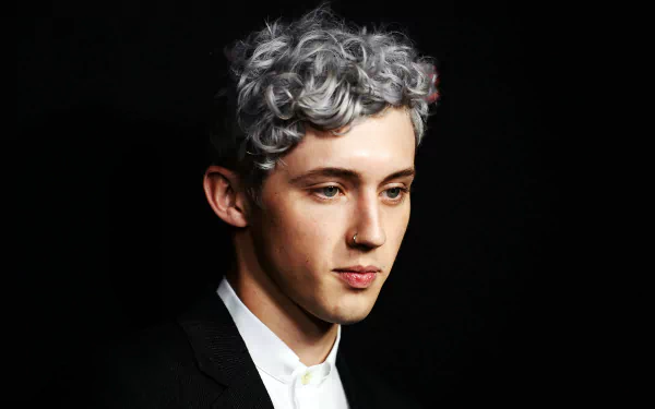 HD desktop wallpaper featuring a person with silver hair and a black jacket against a dark background.