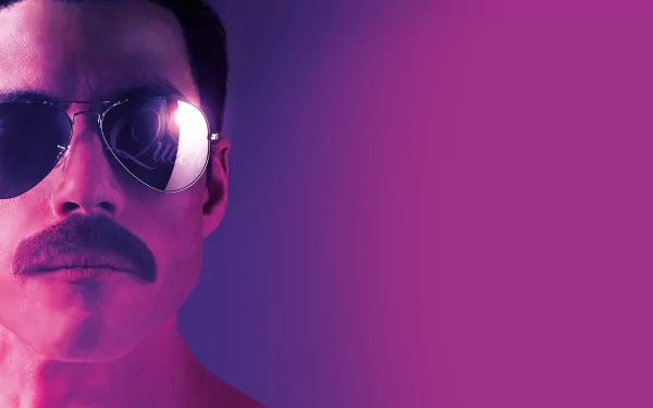 Striking desktop wallpaper featuring a scene from Bohemian Rhapsody movie with Rami Malek portraying Freddie Mercury & the band Queen.