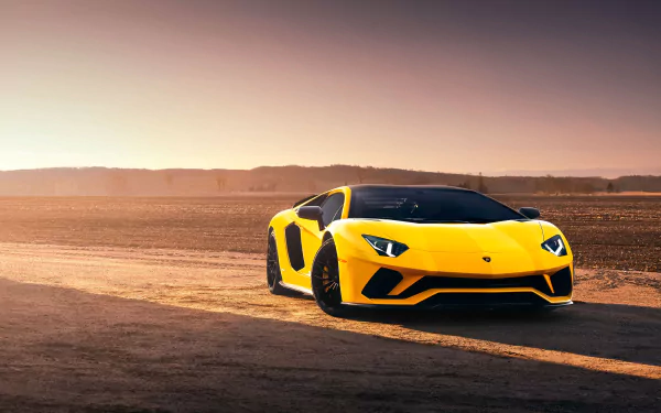 A yellow Lamborghini Aventador S supercar positioned on a desert road at sunset, showcased in stunning 4K Ultra HD desktop wallpaper quality.