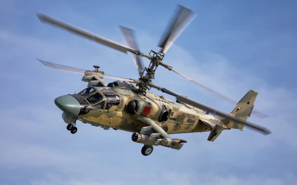 Kamov Ka-52 attack helicopter in flight against a blue sky, showcasing its military design and dual coaxial rotors in this HD aircraft wallpaper.