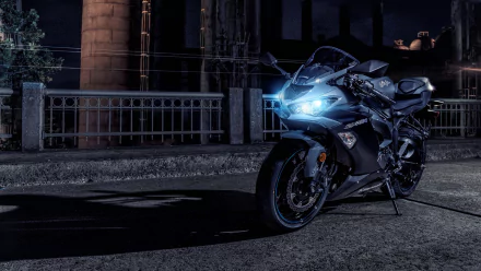 Kawasaki Ninja ZX-6R vehicle on a dim urban bridge at night, blue headlights glowing — 4K Ultra HD PC desktop wallpaper of a Kawasaki sportbike.