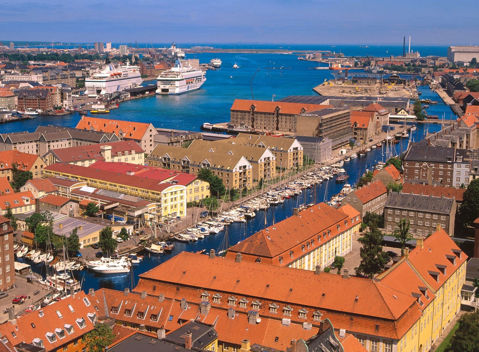 Copenhagen Harbor in Denmark - scenic view of boats and buildings along the water.