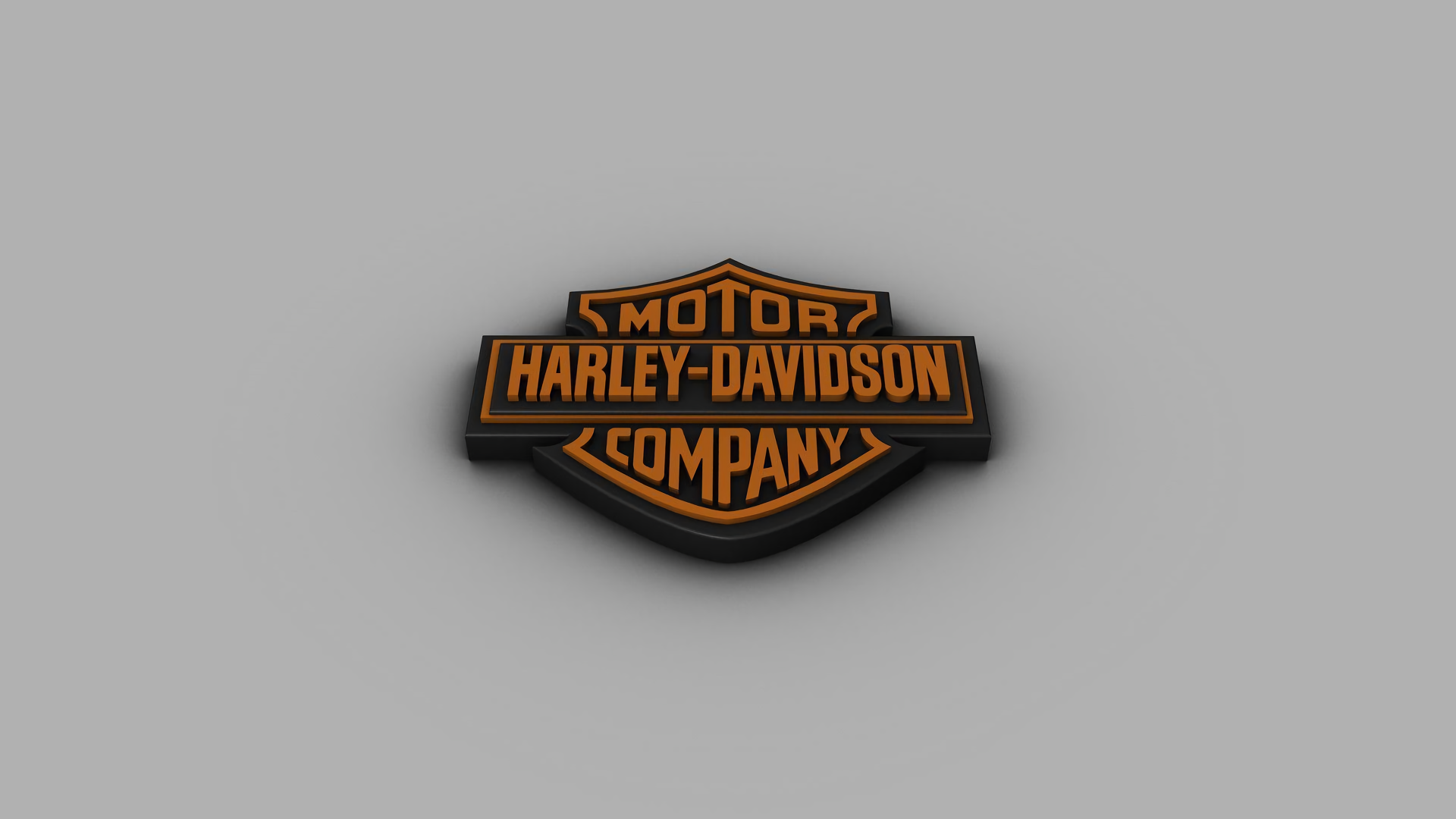 Harley-Davidson logo prominently displayed as a 3D desktop wallpaper with a neutral background.