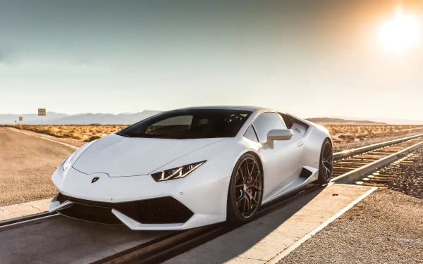 White Lamborghini Huracan sports vehicle parked on a desert road at sunset — 5K Ultra HD PC desktop wallpaper background.